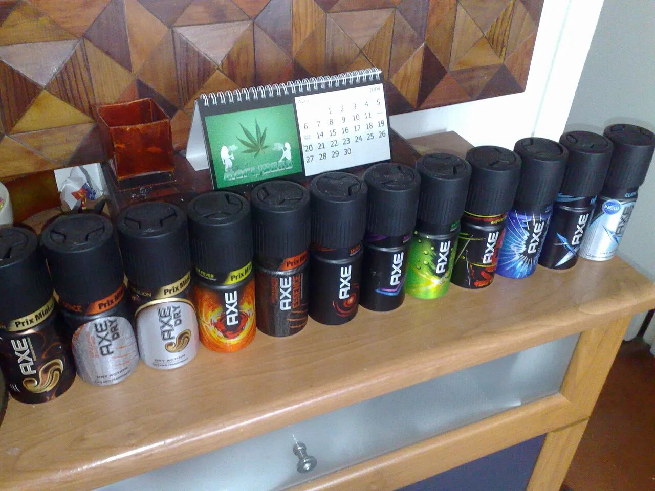 A lineup of various contemporary male grooming sprays and deodorants.